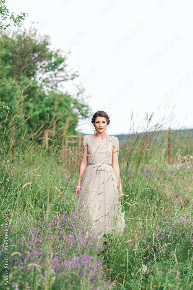 Bride in a beautiful dress with a bouquet of flowers and greener Bride in a beautiful dress with a bouquet of flowers and greener