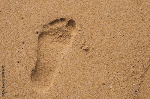 Copy space of footprint on sand beach texture background.