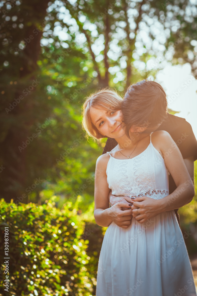 guy and the girl embracing on a background of park guy and the girl embracing on a background of park