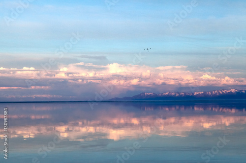 Spring landscape with lake and beautiful reflections, in soft colors, just before sunset