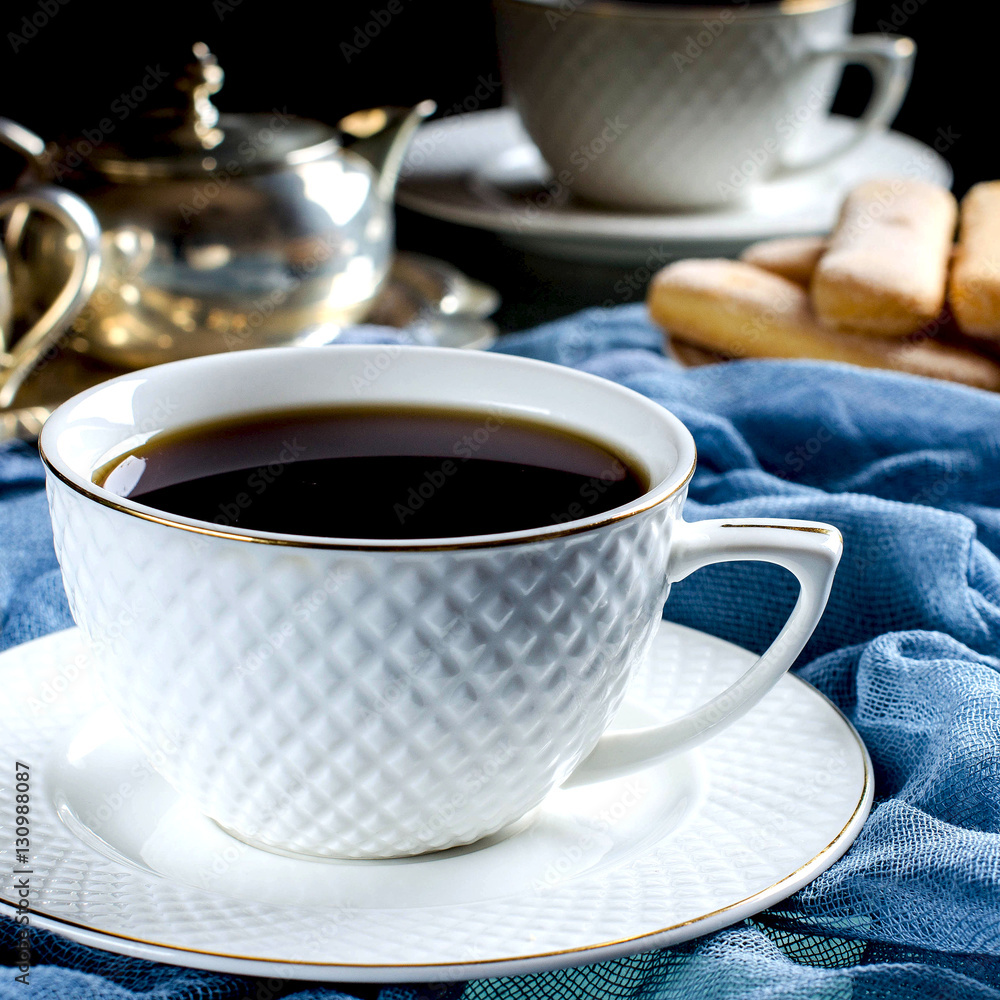 Fototapeta premium Tea in a white Cup. A dark photo.