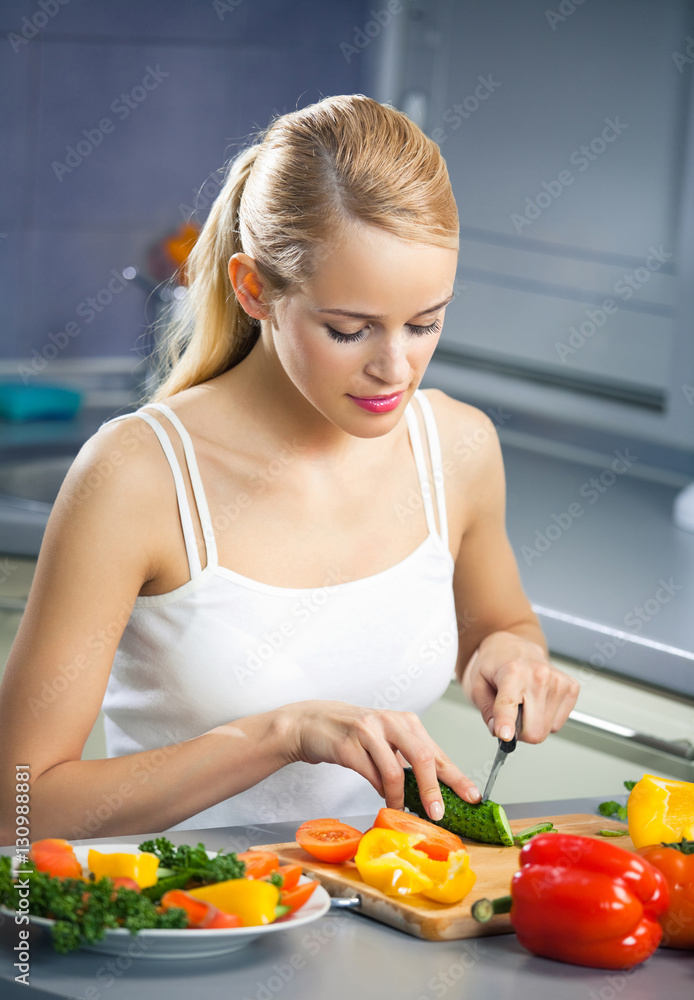 woman making salad at domestic kitchen