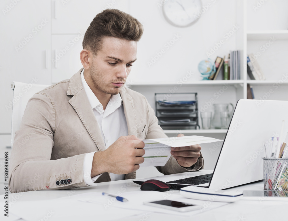 Fototapeta premium Portrait of businessman working in modern office
