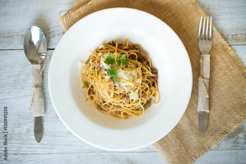 Spaghetti with tomato paste, hot Chili peppers and olive oil. On rustic background. Top view