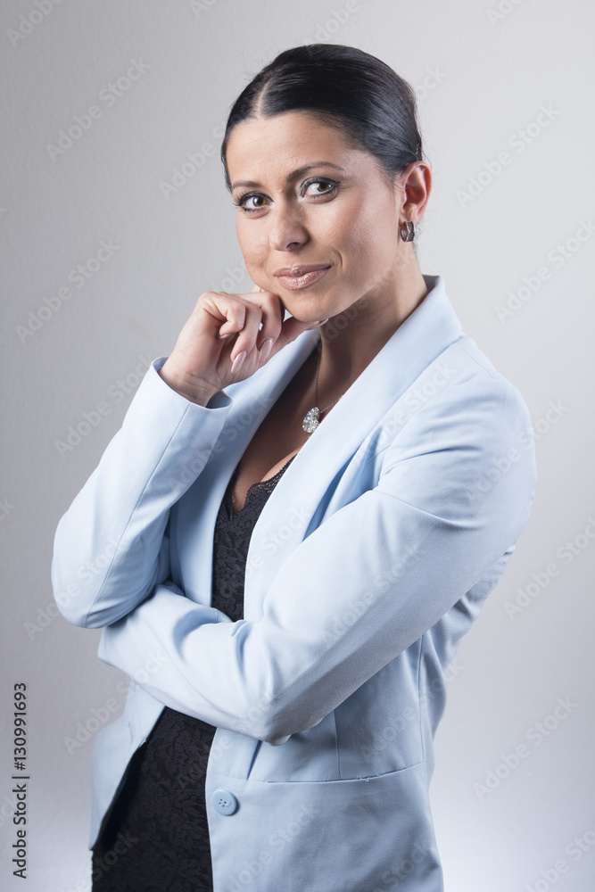 Elegantly dressed young business woman posing. Elegantly dressed young business woman posing.