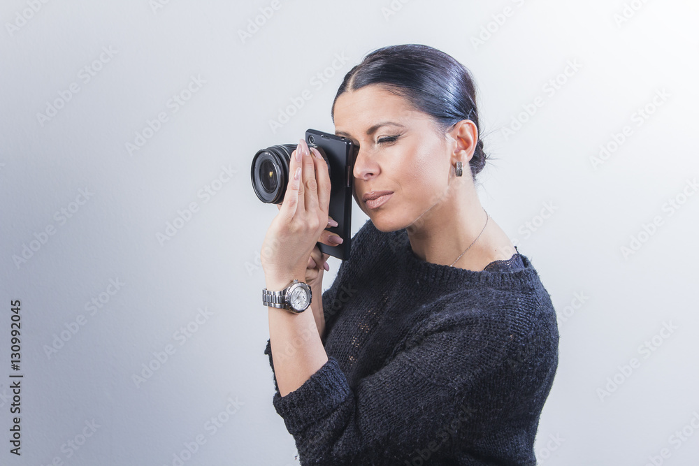 Young woman focusing an interchangeable lens without a camera Young woman focusing an interchangeable lens without a camera