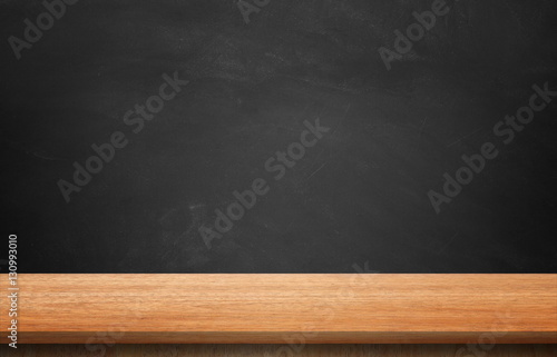 Wooden table and blackboard background.