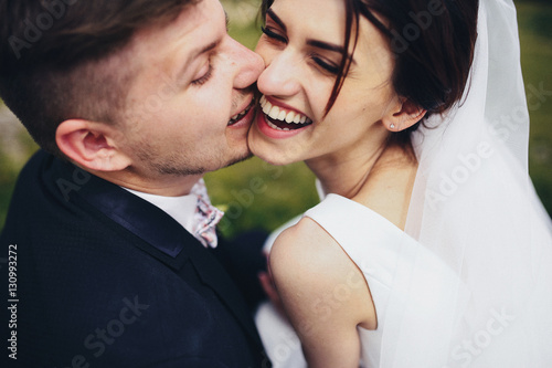 The groom kissing his bride