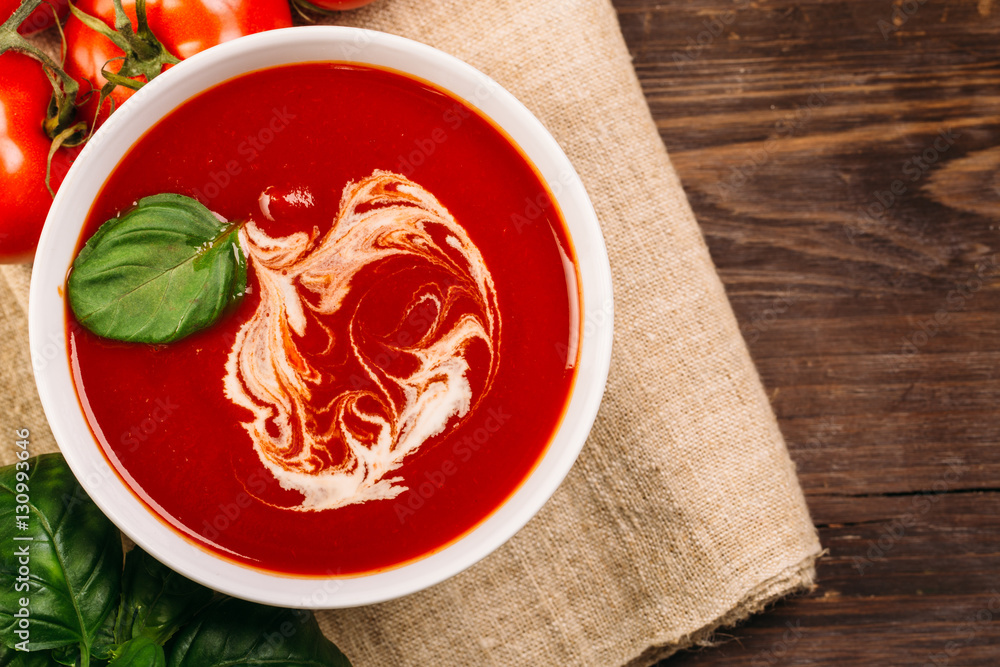 Homemade tomato soup on wooden table, top view Homemade tomato soup on wooden table, top view
