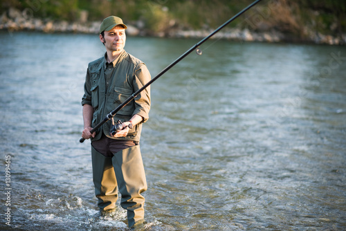 Fisherman fishing in a river