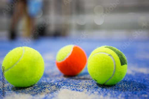 Paddle tennis balls on blue turf in court. © nenetus