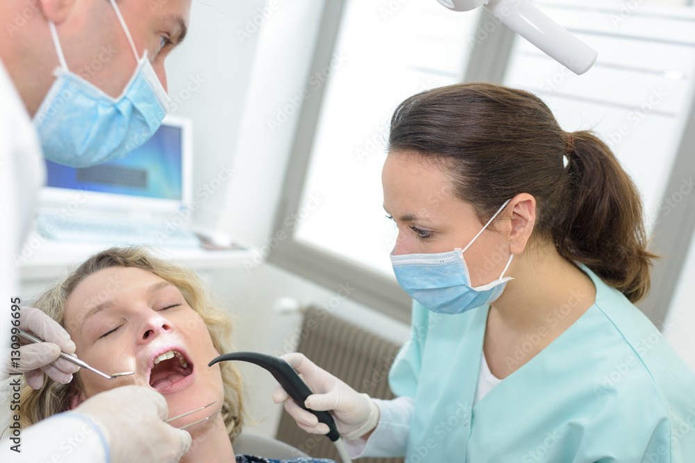 dentist curing a female patient dentist curing a female patient