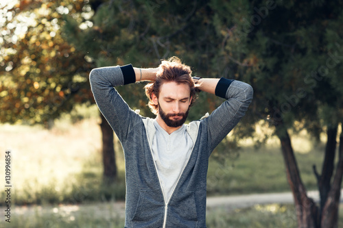 Excited man touching his head in park. Happy man feeling joy, happiness, pleasure of being in forest, free space. Overabundance of emotions, Indian summer, life love, new beginnings concept © golubovy