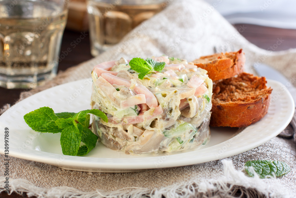 Salad with ham and mushrooms on white plate Salad with ham and mushrooms on white plate