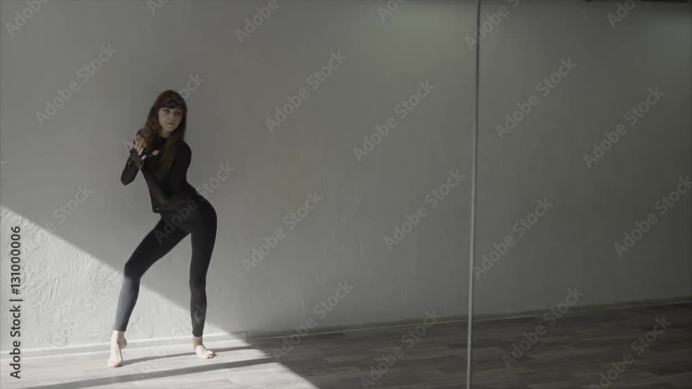 Young pretty woman in black dancing in studio slow motion HD Young pretty woman in black dancing in studio slow motion HD