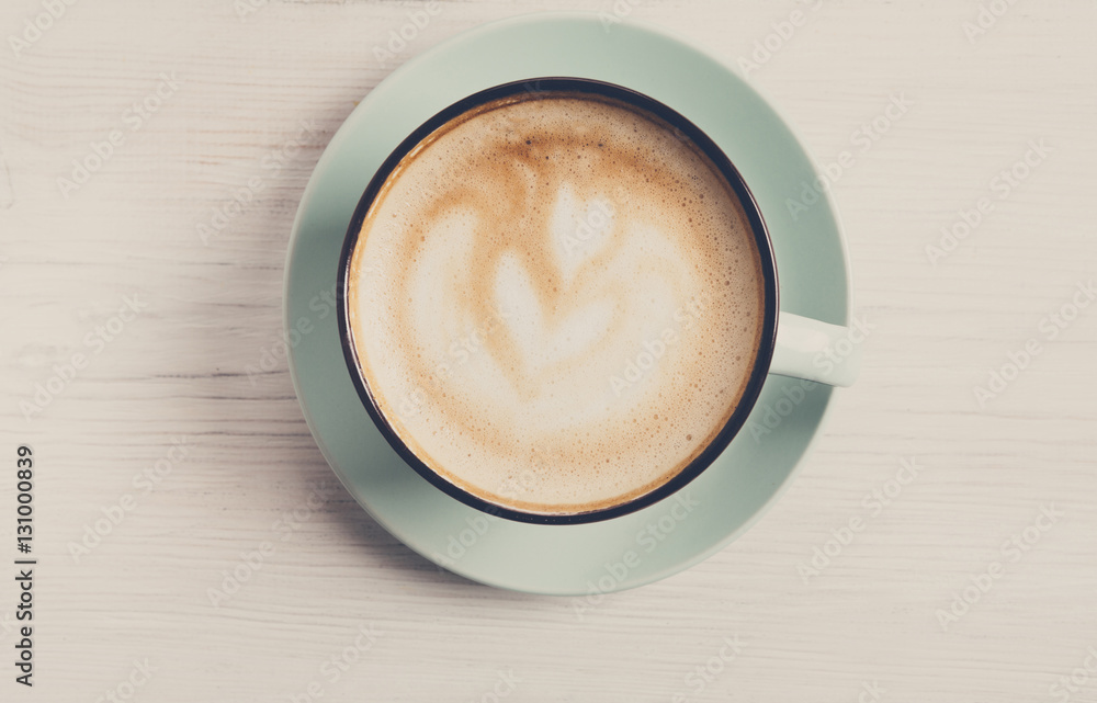 Cappuccino foam, coffee cup top view on white wood background Cappuccino foam, coffee cup top view on white wood background