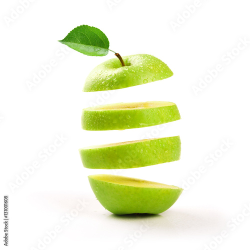 sliced green apple levitating on white background