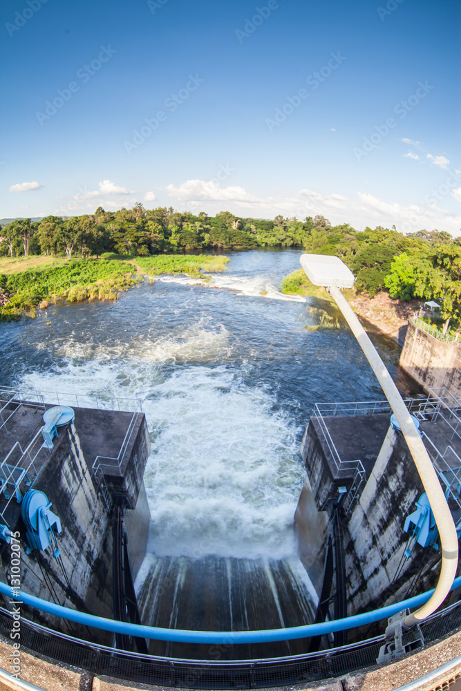 Water flowing from the open sluice gates of dam.