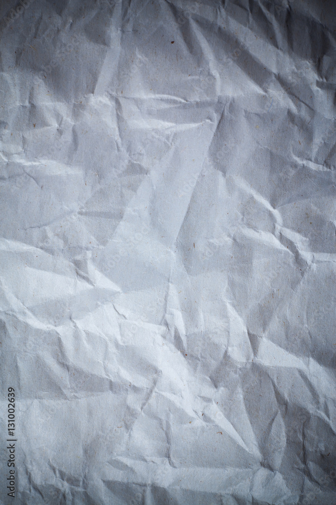 Fototapeta premium Recycled crumpled gray paper background dark edged.