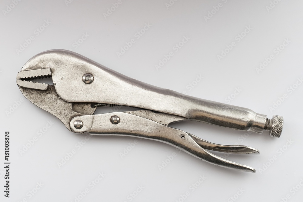 Locking pliers, close up / Locking pliers with closed jaws isolated on white background Locking pliers, close up / Locking pliers with closed jaws isolated on white background