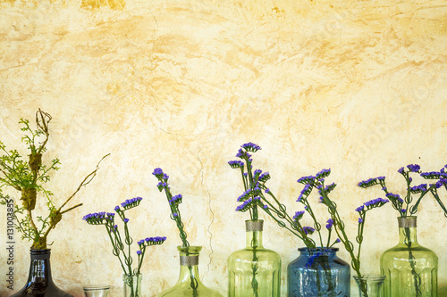 Decorative lavender flowers in vintage style glass bottles