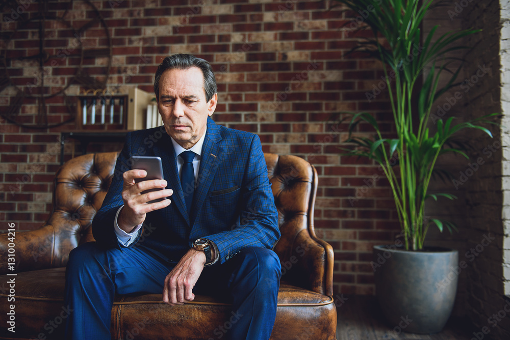 Serious middle aged businessman in room Serious middle aged businessman in room