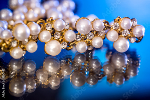 White pearls collier isolated on black blue background.