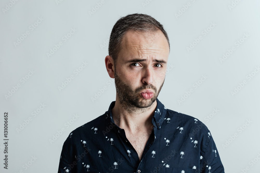 Young amusing male in studio
