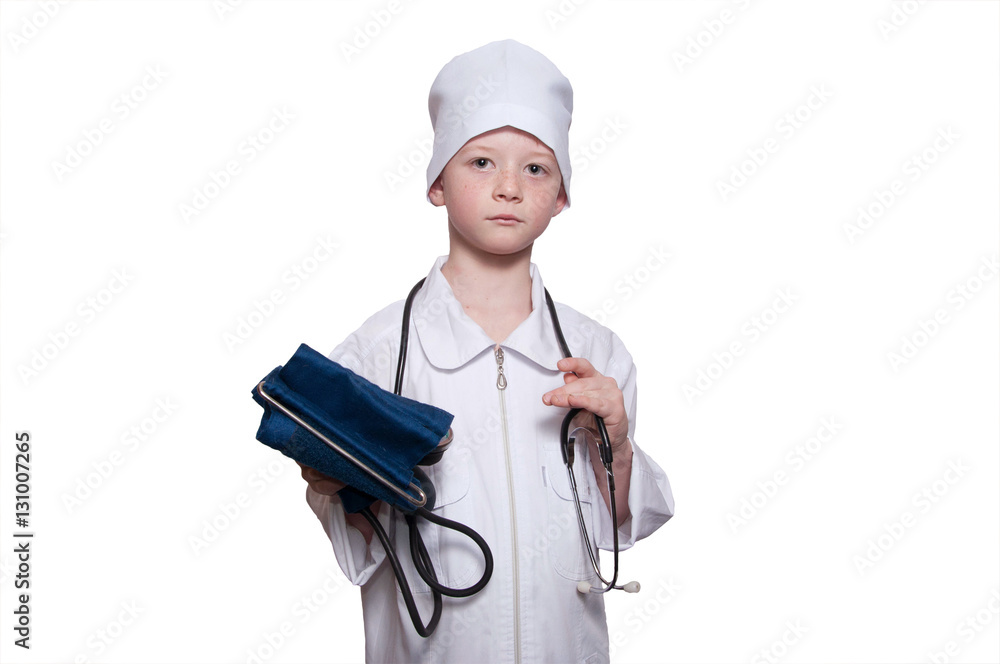 Child in a medical gown, cap, mask, stethoscope, sphygmomanomete Child in a medical gown, cap, mask, stethoscope, sphygmomanomete