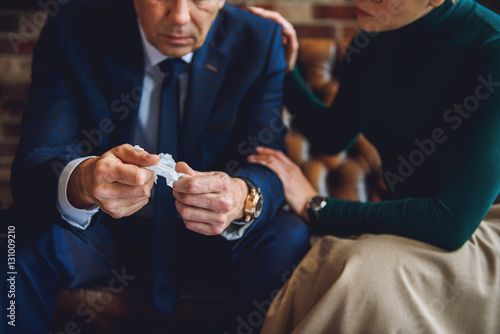 Worried senior man holding napkin