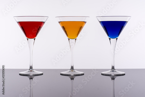 Colorful Cocktails in Martini Glasses Background. Bar Commercials Concept.