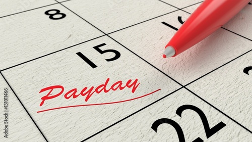 Red ballpen on a paper calendar closeup