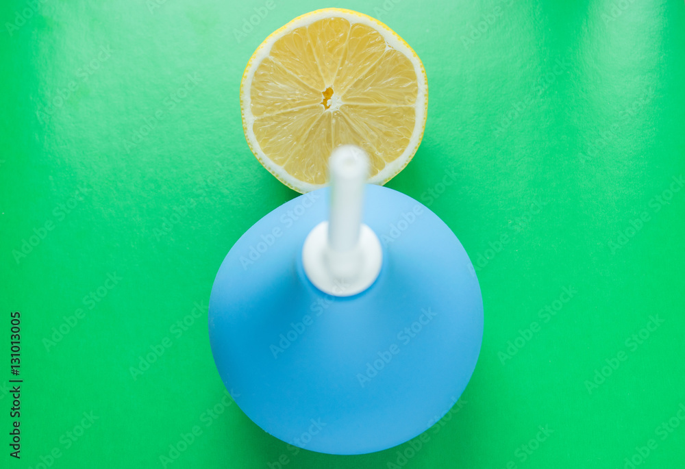 Blue medical enema and fresh lemon - dieting and medical concept Blue medical enema and fresh lemon - dieting and medical concept