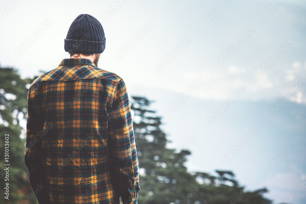 Man Traveler hiking forest and mountains on background Travel Fashion Lifestyle adventure vacations concept Man Traveler hiking forest and mountains on background Travel Fashion Lifestyle adventure vacations concept