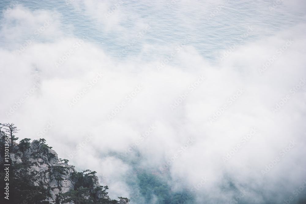 Clouds Foggy Mountains cliff and sea Landscape minimalistic style Travel serene scenic aerial view moody weather