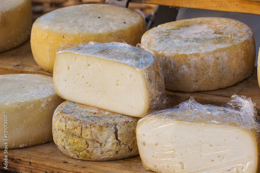 Different sorts of italian cheese produced from goat milk in market.