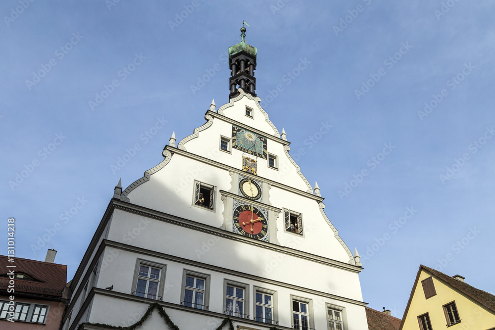 Peak Of A Building With A Clock Against A Blue Sky in Rothenburg