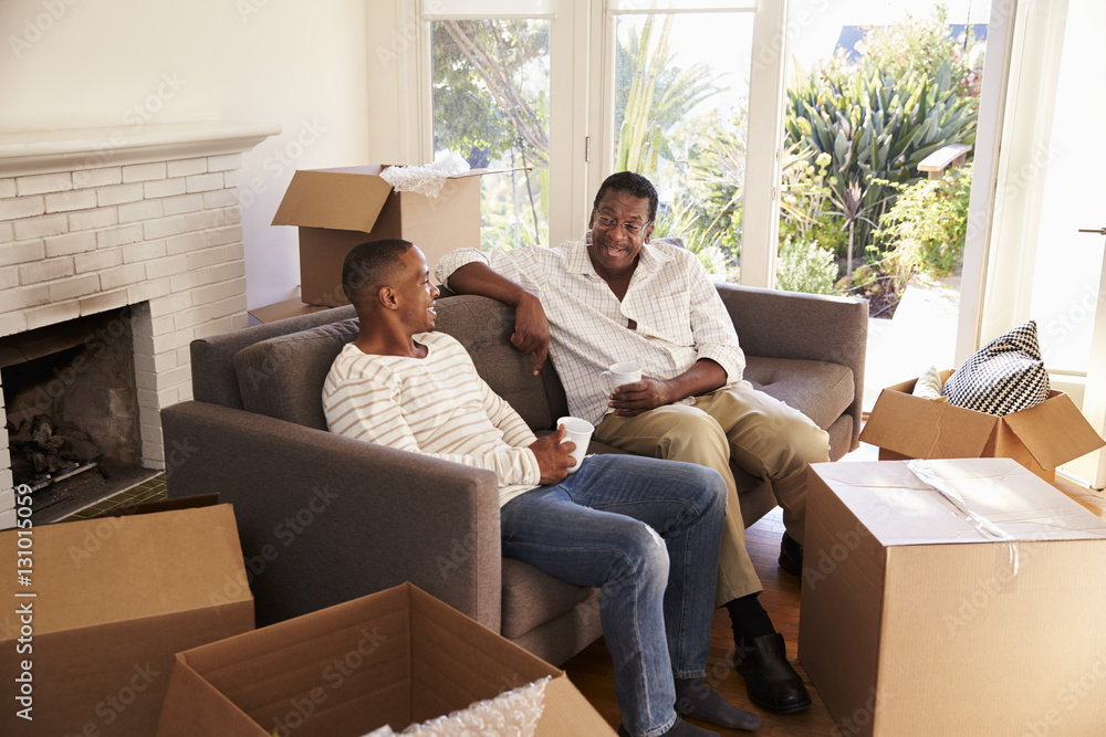 Father And Adult Son Take A Break With Pizza On Moving Day Father And Adult Son Take A Break With Pizza On Moving Day