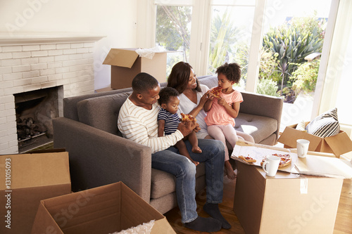 Family Take A Break On Sofa With Pizza On Moving Day © Monkey Business