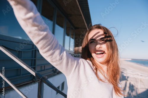 Woman in sweater covering from the sun