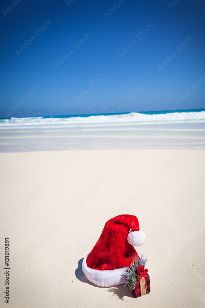 Santa Hat and gifts on beach Santa Hat and gifts on beach