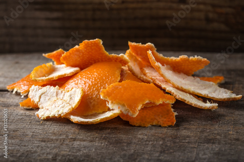 Fresh orange peels on wood
