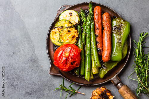 Grilled vegetables zucchini, asparagus, bell pepper, sausages on grill pan
