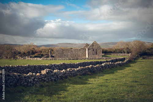 Gloomy weather with lead sky at the histroric Kilmacduagh monastery, Ireland photo