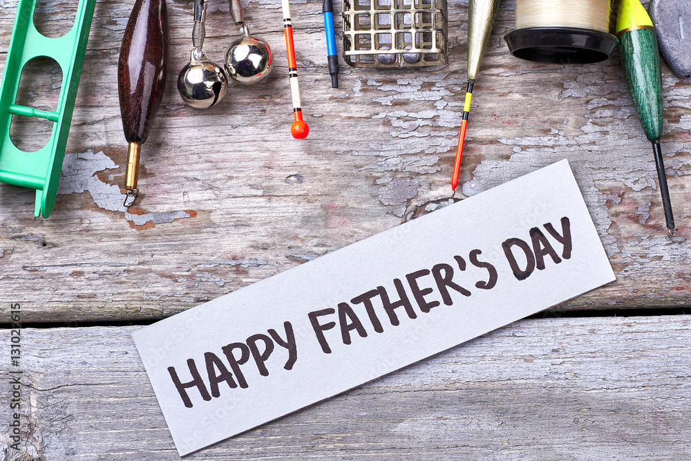 Happy Father's Day greeting paper. Fishing tackle near card. Relaxing  weekend for dad. Stock Photo