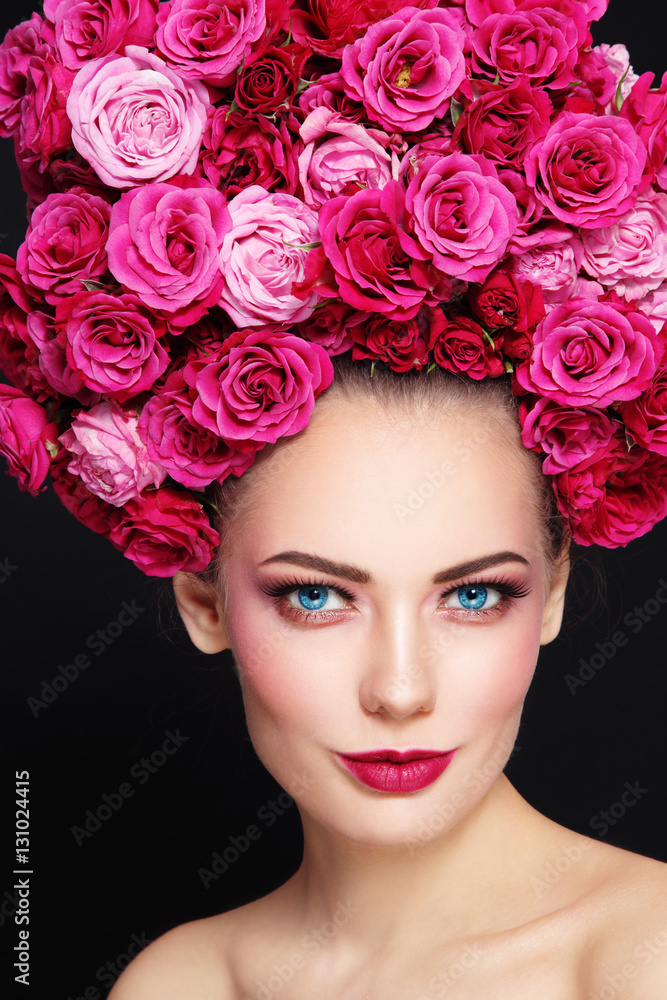 Portrait of young beautiful happy smiling woman with stylish make-up and wig of roses