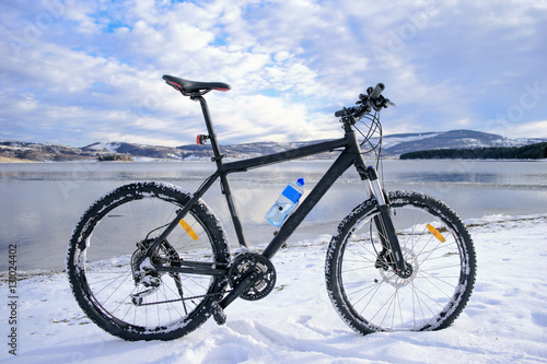 Mountain bike on lake. Winter