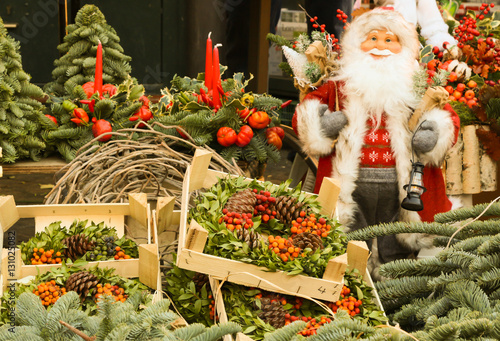 Santa Claus with some Christmas decoration in a pubblic market in Rome, Italy