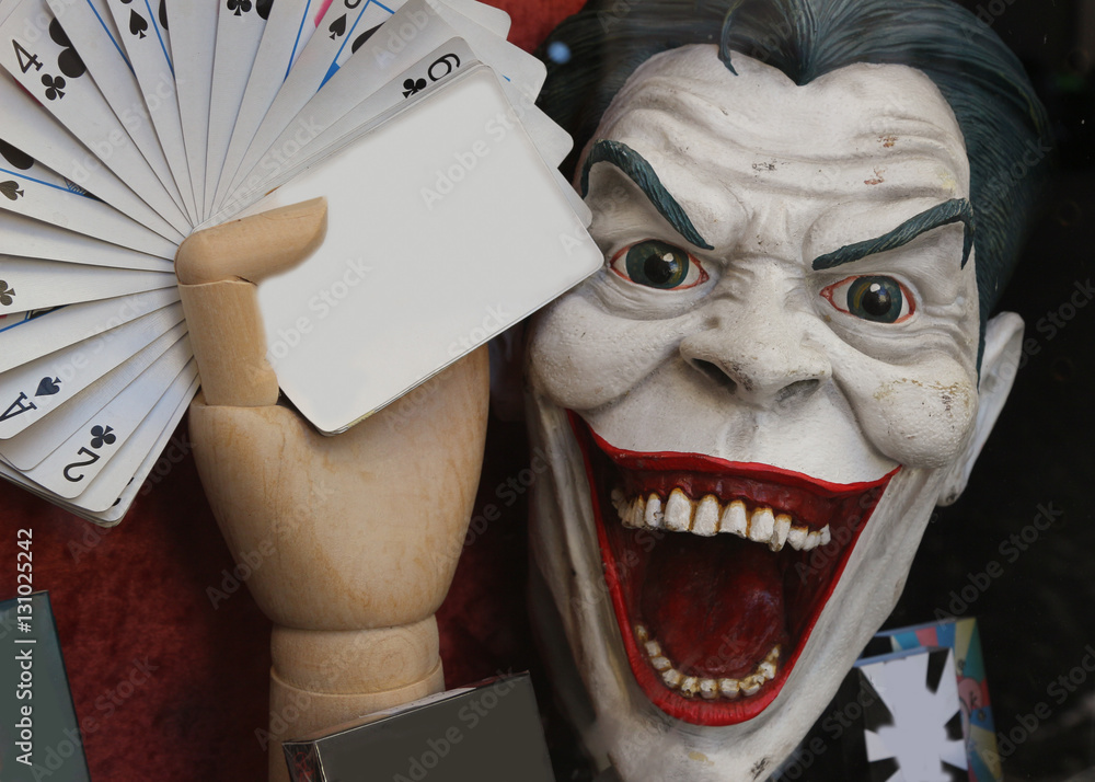 crazy joker face with cards and white empty card to write messag