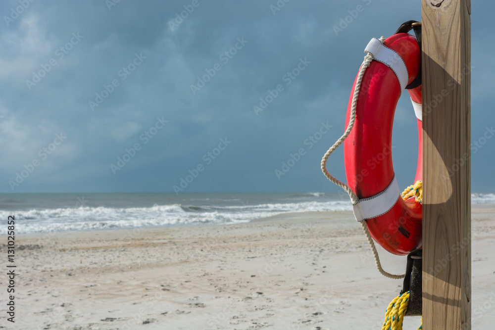 Lifeguard station on the beach. Life preserver on a pole. Safety. Emergency flotation device.